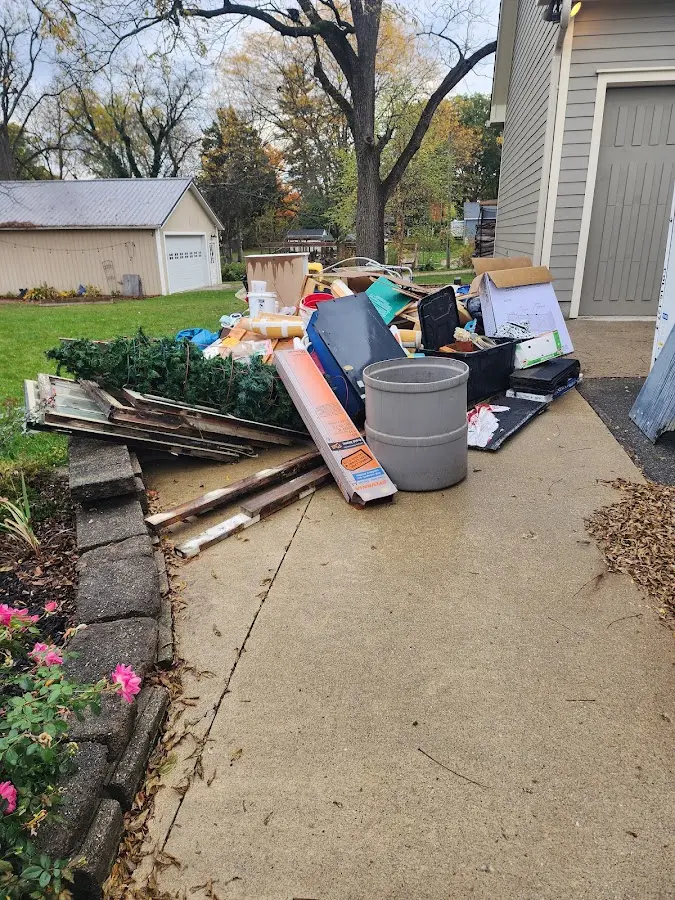 Dumpster being loaded with debris for Estate Cleanout Dumpster Rental in Cullowhee
